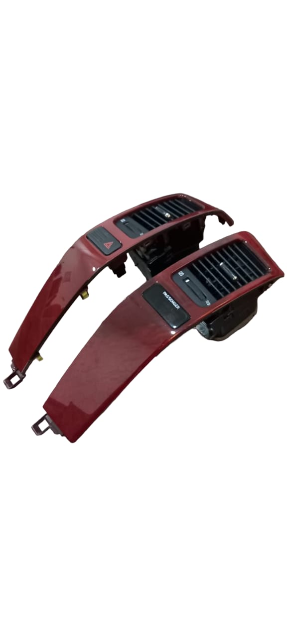 Angled top view of Lexus GX470 center dash air vent panels model 55474-60110 and 55475-60110, highlighting air flow direction switches and control knobs.

